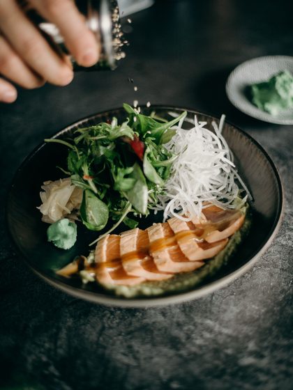 Seared chicken over rice noodles and greens