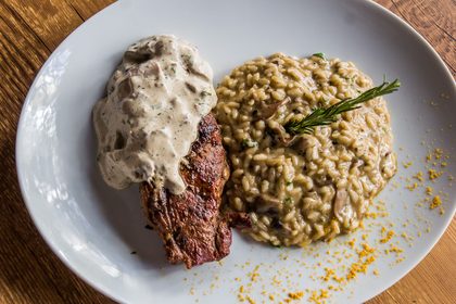 Steak with mushroom sauce and risotto