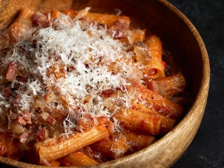 Rigatoni in tomato sauce, finished with grated cheese