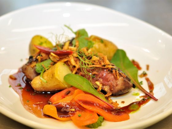 Duck breast with glazed carrots and greens