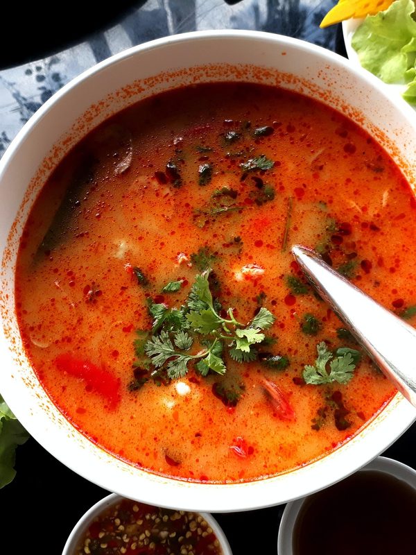 A bowl of tomato soup with sides